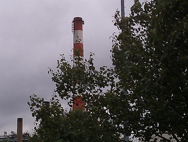 FM antenna mounted on the side of a smokestack
