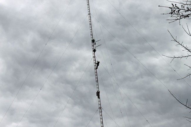 Tower crew hanging translator antenna on AM tower